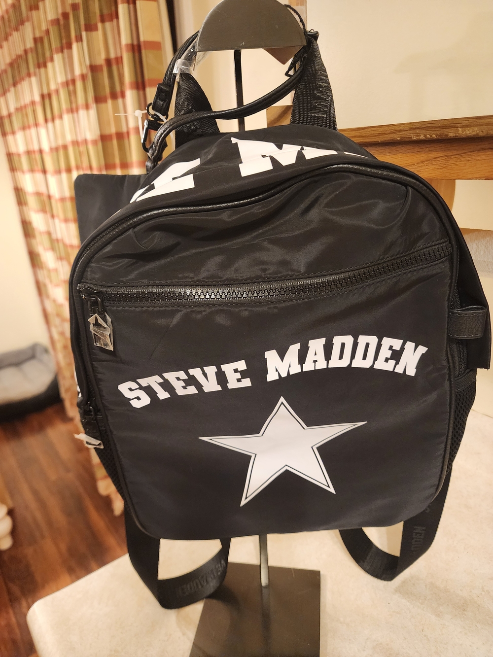 black Steve Madden nylon backpack featuring a white star graphic